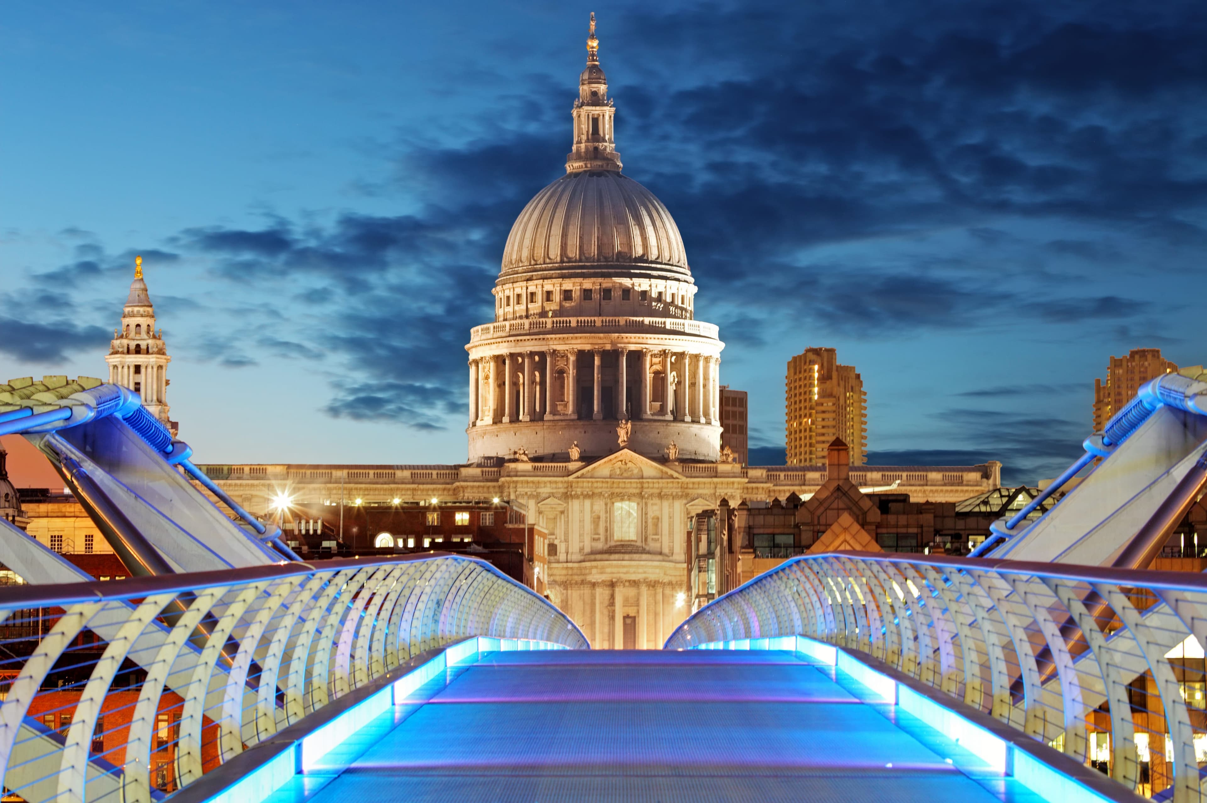 St Paul's Cathedral and Millennium Bridge illuminated at night in London